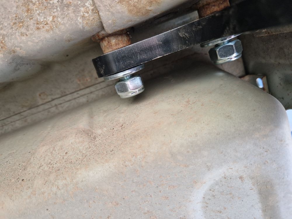 Towbar bracket bolted on left-hand side.