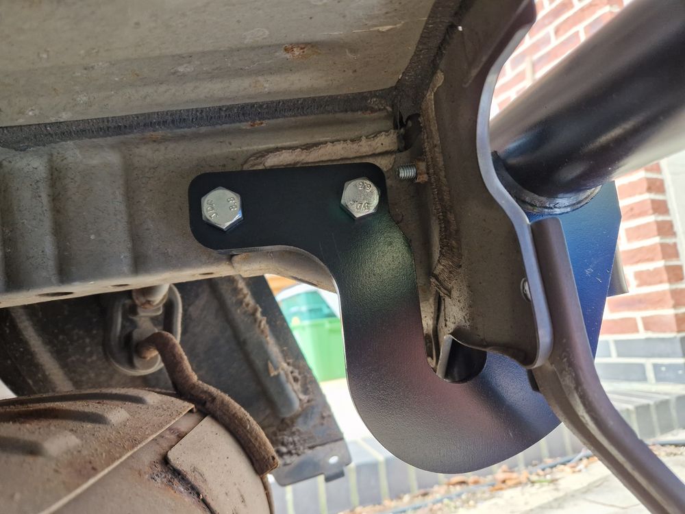 Towbar bracket bolted on right-hand side.